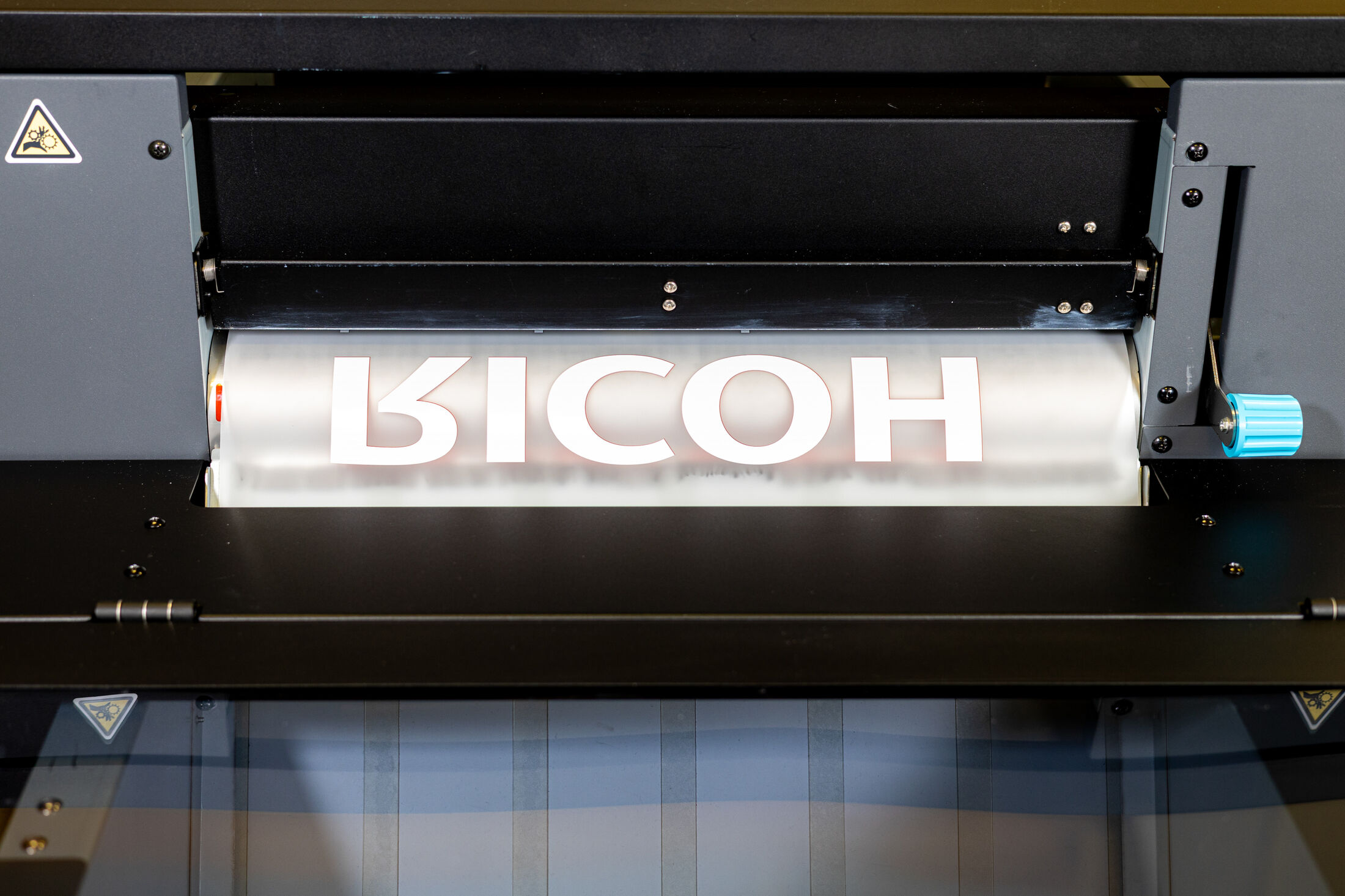 Printed DTF film with RICOH lettering inside the XTF D430