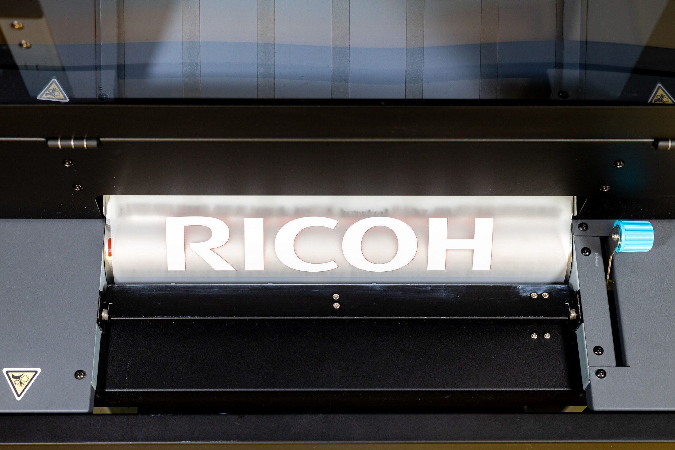Printed DTF film with RICOH lettering inside the XTF D430